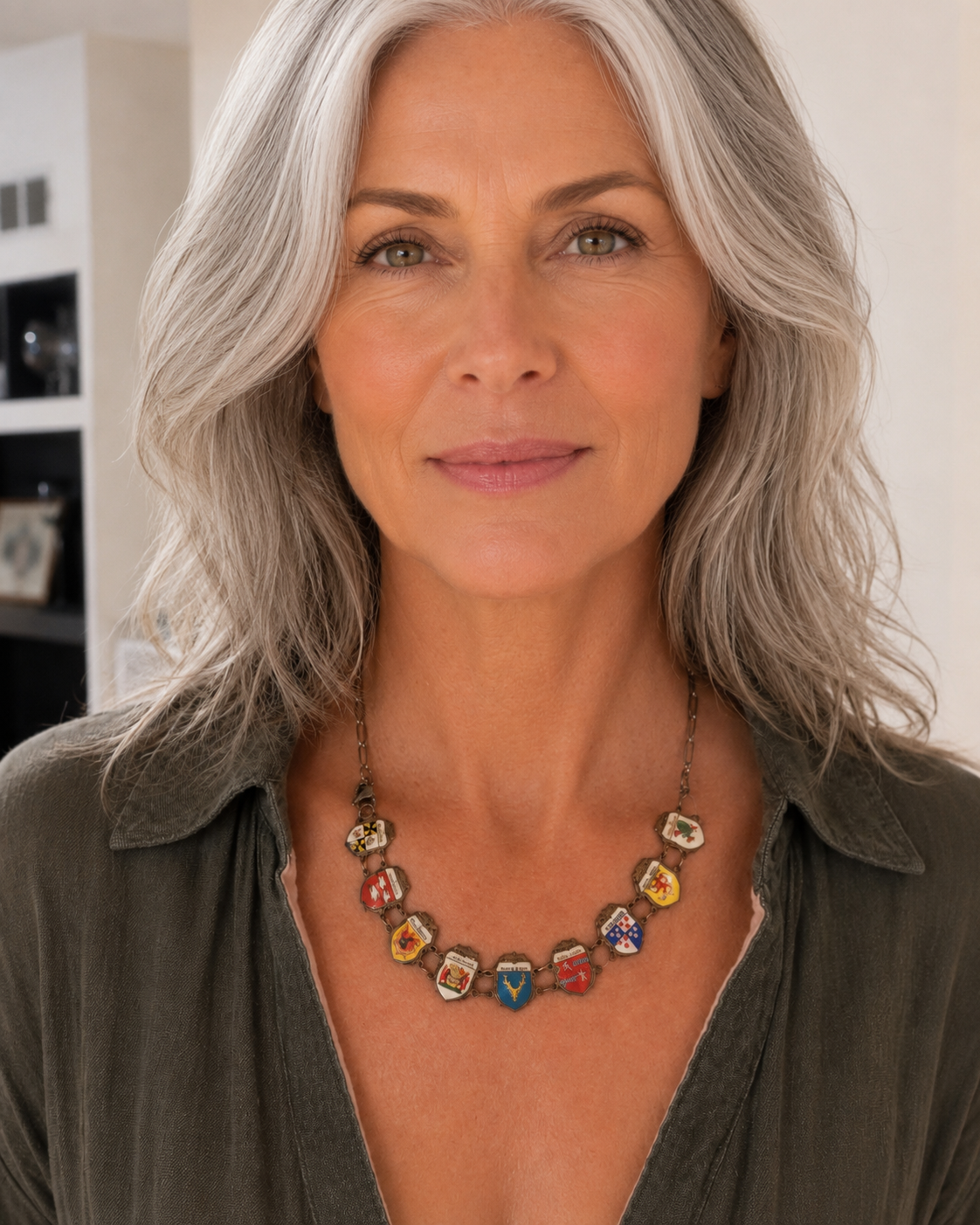 Woman wearing a vintage European shield travel charm bracelet as a necklace on a CharmFlip chain