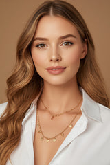 Woman wearing CharmFlip gold chain necklace layered over an open white shirt