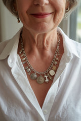 Woman wearing her heirloom silver charm bracelet as a necklace with the CharmFlip 10 inch silver chain