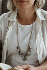 Silver charm bracelet worn as a long necklace with the CharmFlip 12 inch silver extension chain