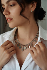 Woman wearing a vintage silver charm bracelet as a necklace with the CharmFlip 8 inch silver chain