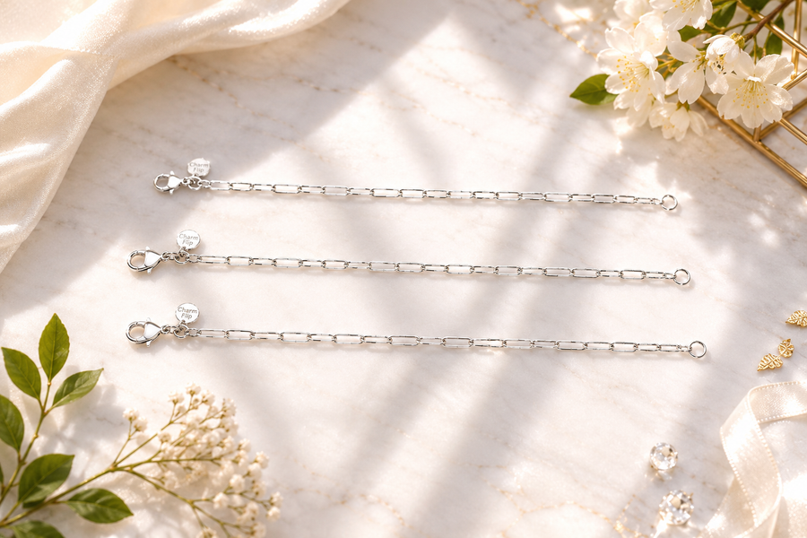 CharmFlip silver extension chains in 8, 10 and 12 inch lengths, flat lay on marble