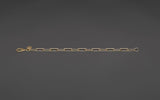360 degree rotating view of the CharmFlip 8 inch gold paperclip extender chain with lobster clasp, on dark velvet