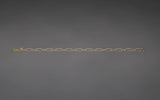 CharmFlip gold 12 inch extender chain rotating 360 degrees on dark gray velvet