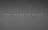 CharmFlip silver 12 inch extender chain rotating 360 degrees on dark gray velvet