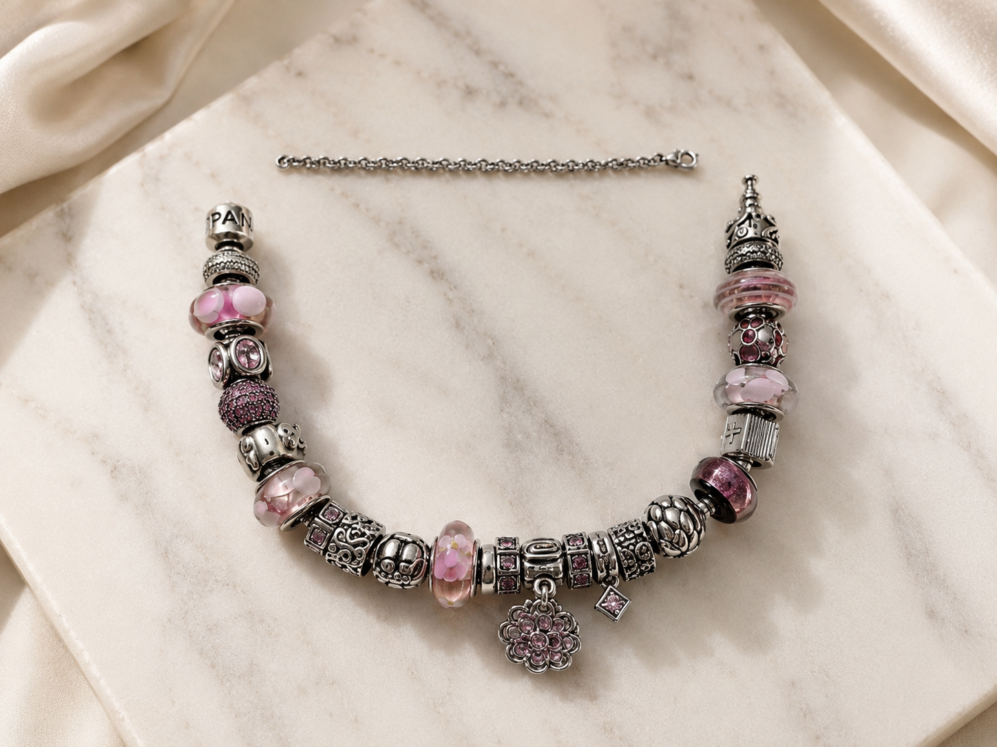 Open Pandora bracelet beside the safety chain that was cut away